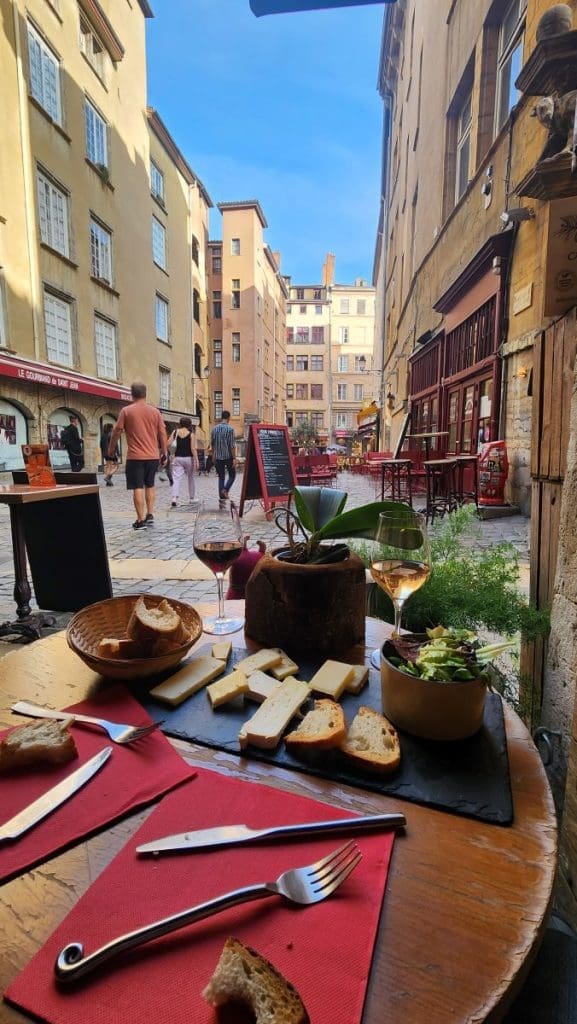 wine and cheese on a table in old town Lyon in france